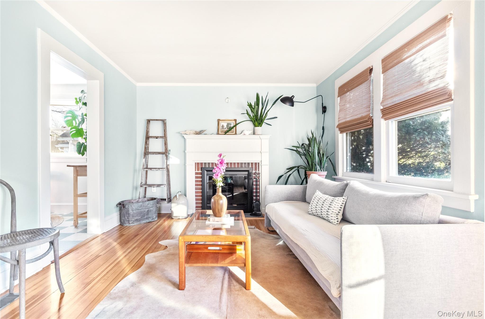 47 Station Road Bellport, NY 11713 - Photo 2 of 13 a living room with fireplace furniture and a large window