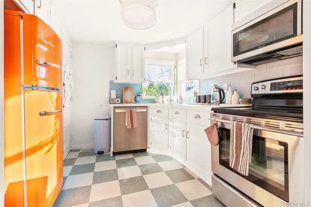 a kitchen with a stove a sink and a refrigerator