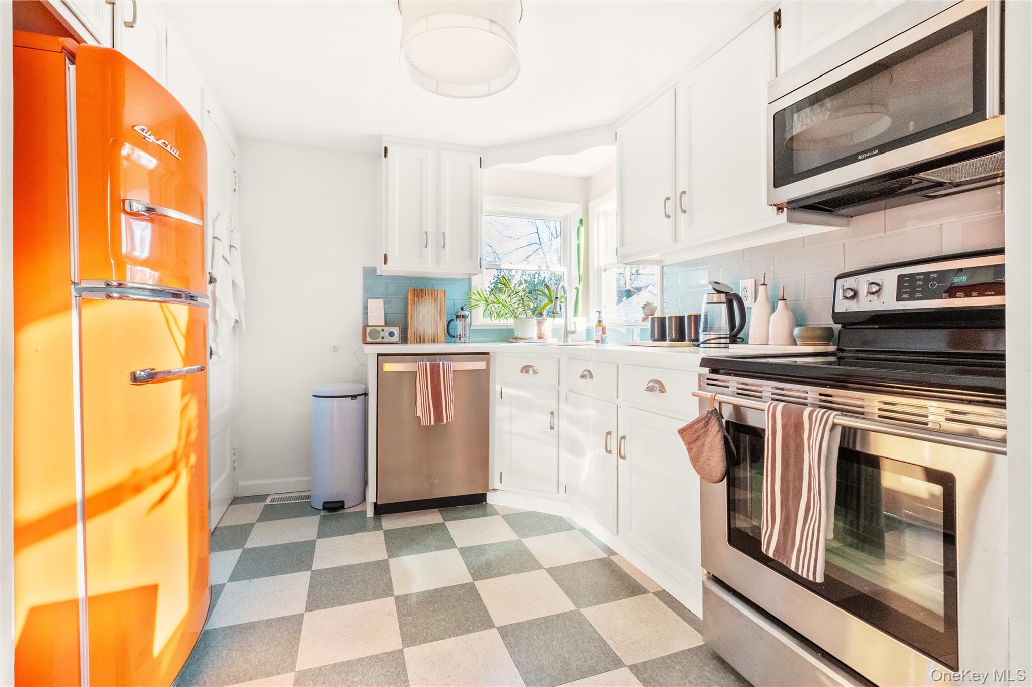 47 Station Road Bellport, NY 11713 - Photo 4 of 13 a kitchen with a stove a sink and a refrigerator