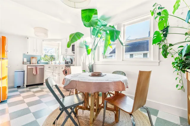 a dining room filled with furniture and potted plants