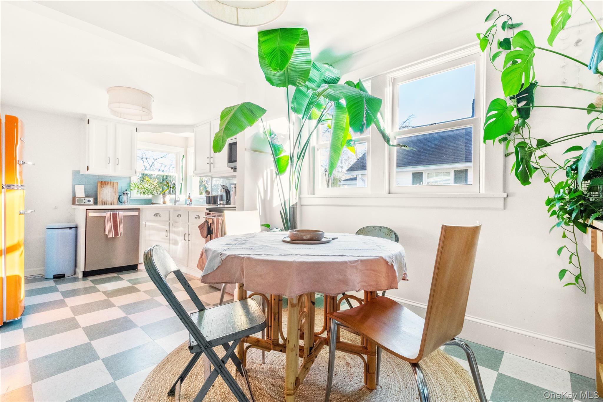 47 Station Road Bellport, NY 11713 - Photo 5 of 13 a dining room filled with furniture and potted plants