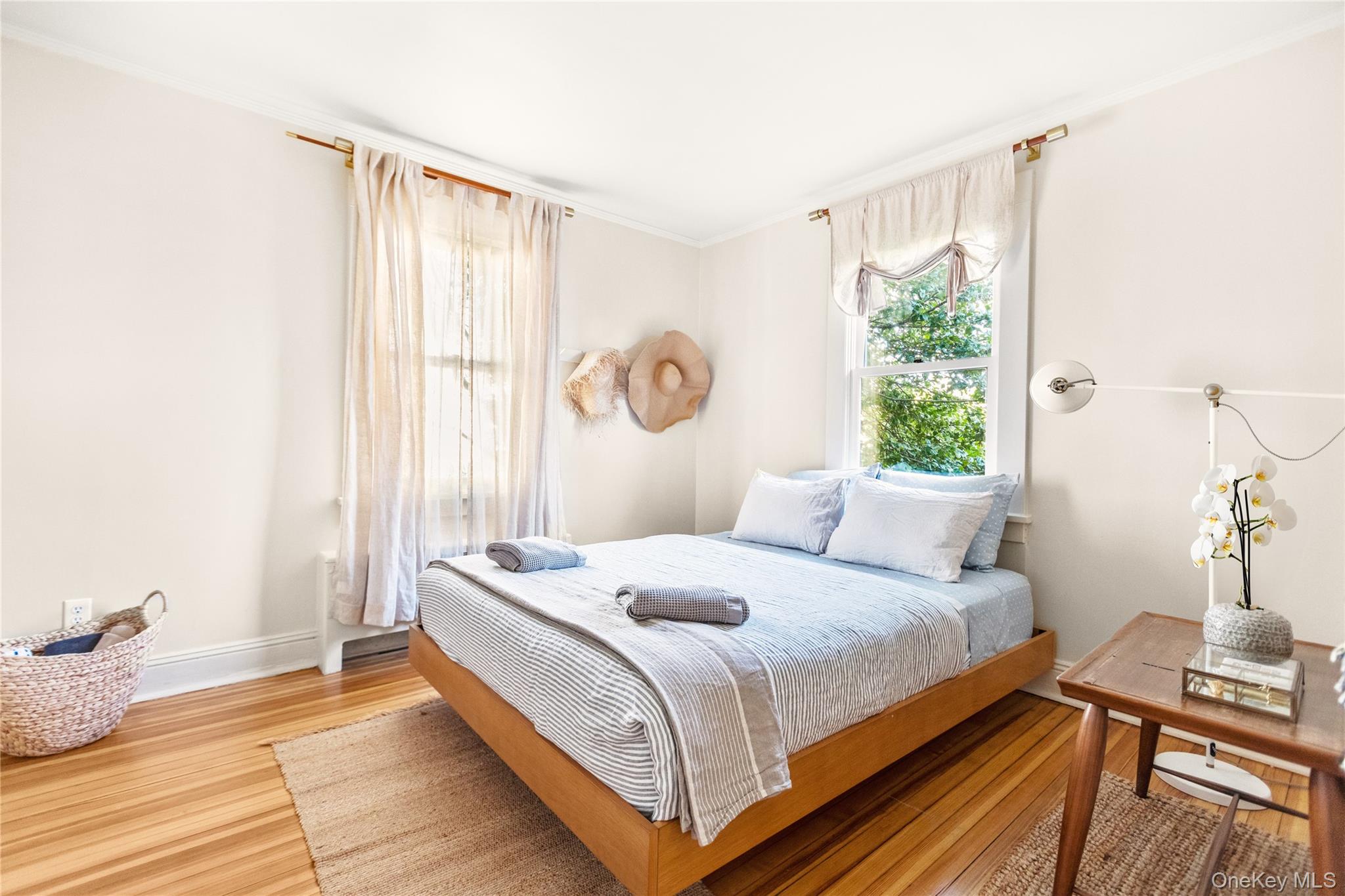 47 Station Road Bellport, NY 11713 - Photo 6 of 13 a bedroom with a bed and a window