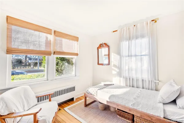 a bedroom with furniture and a window