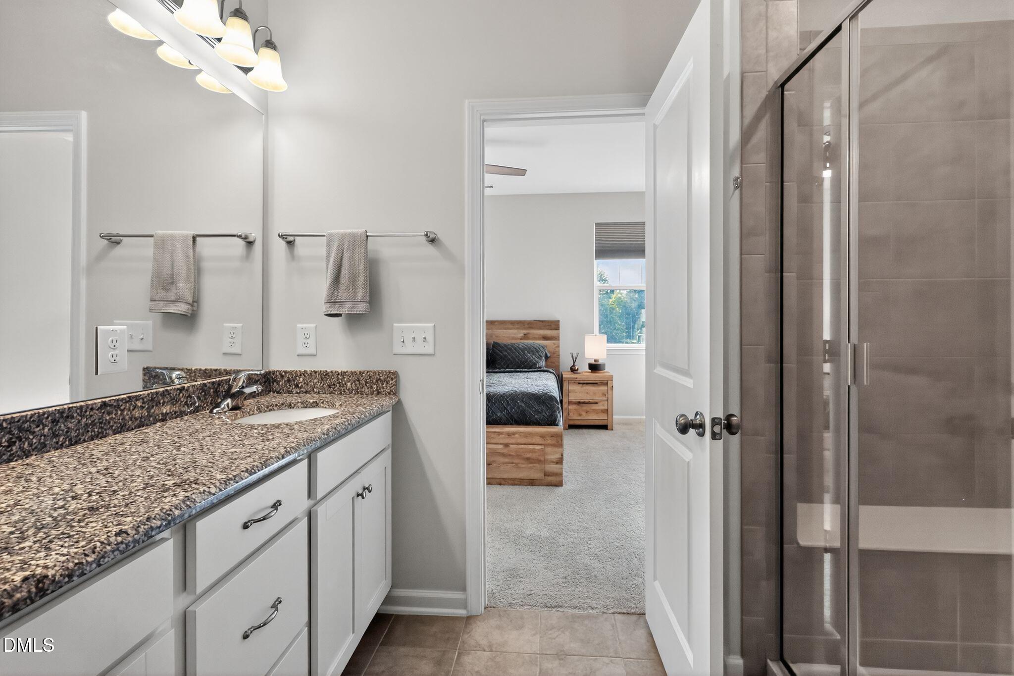 1118 Commack Drive Durham, NC 27703 - Photo 11 of 30 a spacious bathroom with a granite countertop sink a mirror and shower