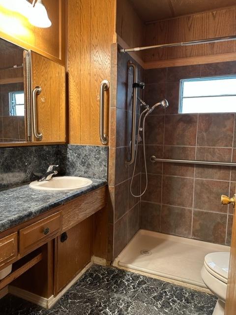 1272 Villa Avenue, Unit 1 Clovis, CA 93612 - Photo 4 of 18 a bathroom with a granite countertop sink a toilet a mirror and shower