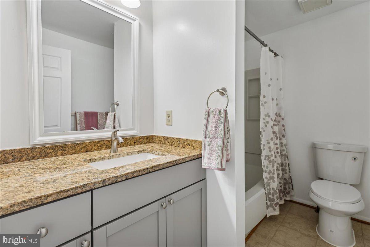 10921 Harpers Square Court Reston, VA 20191 - Photo 13 of 33 a bathroom with a granite countertop sink toilet and shower