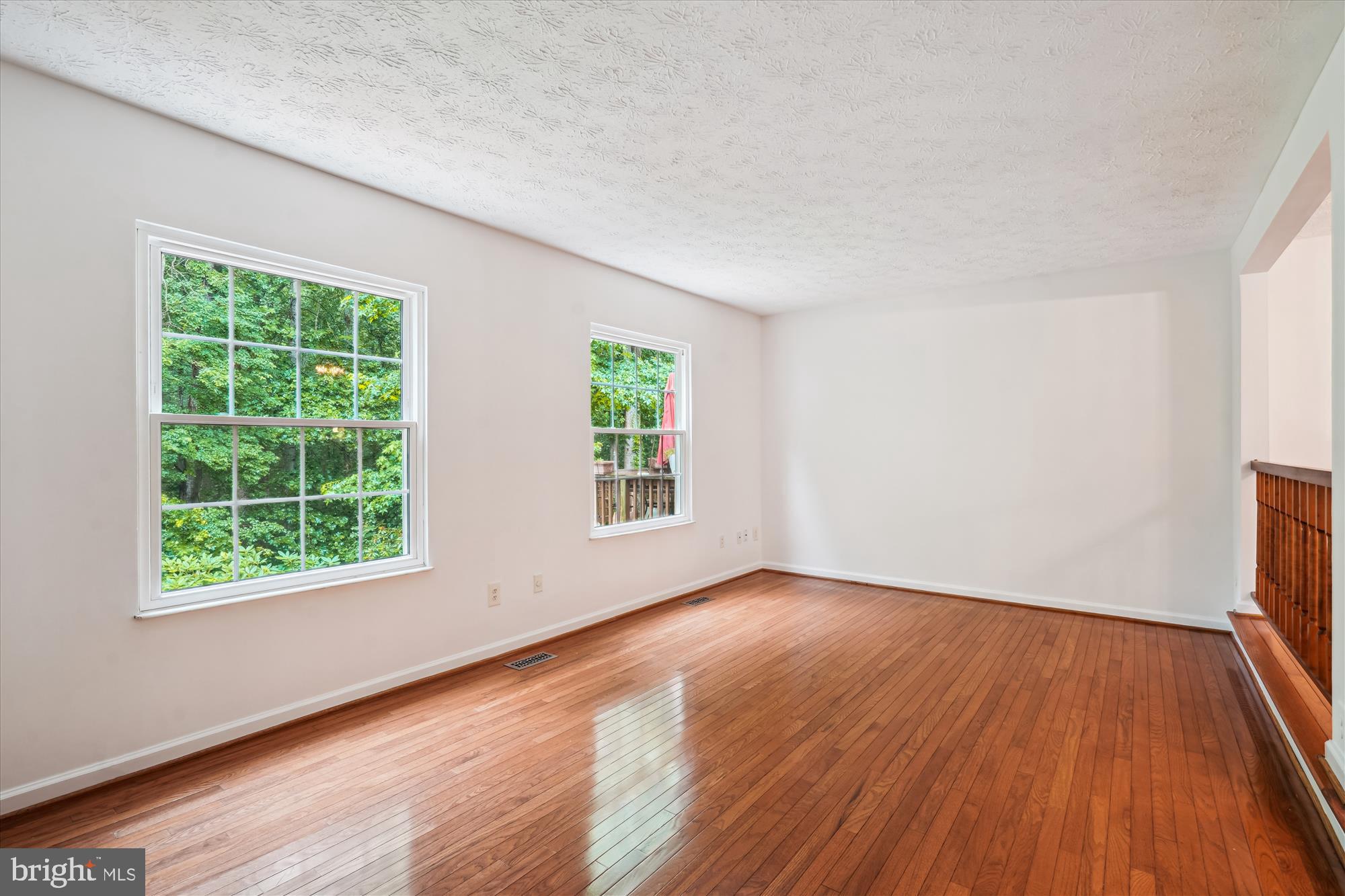 10921 Harpers Square Court Reston, VA 20191 - Photo 25 of 33 an empty room with wooden floor and windows