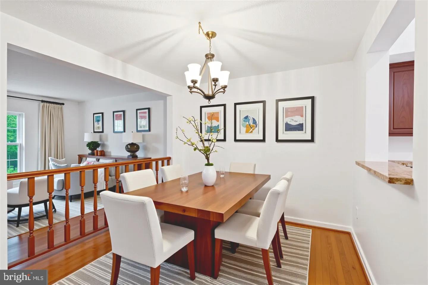 10921 Harpers Square Court Reston, VA 20191 - Photo 3 of 33 a view of a dining room with furniture and a chandelier