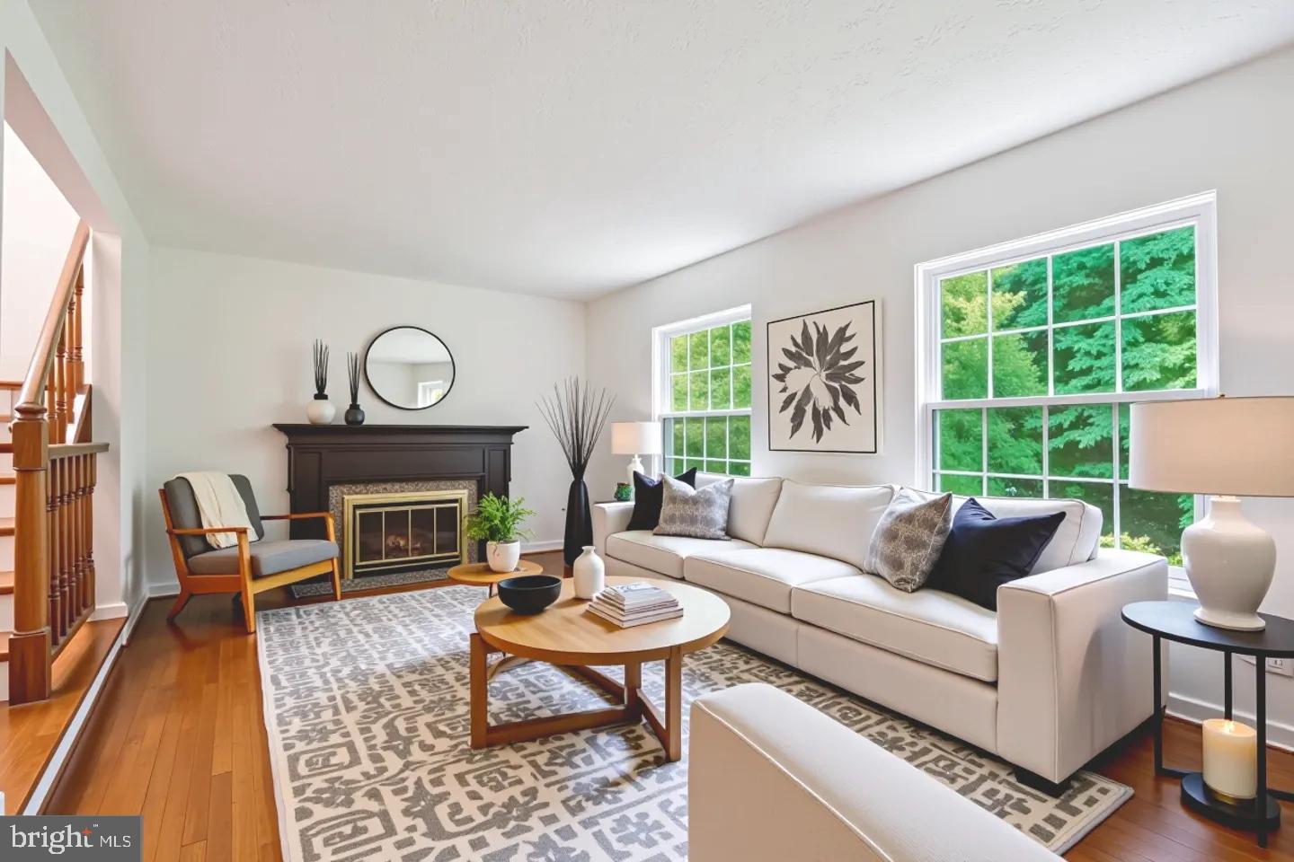 10921 Harpers Square Court Reston, VA 20191 - Photo 4 of 33 a living room with furniture a rug a fireplace and a large window