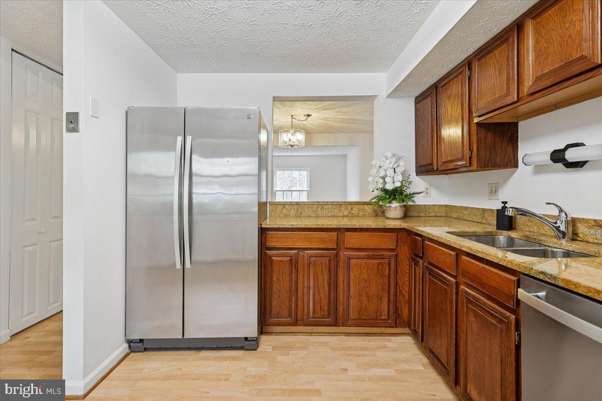 10921 Harpers Square Court Reston, VA 20191 - Photo 6 of 33 a kitchen with stainless steel appliances granite countertop a refrigerator and a sink