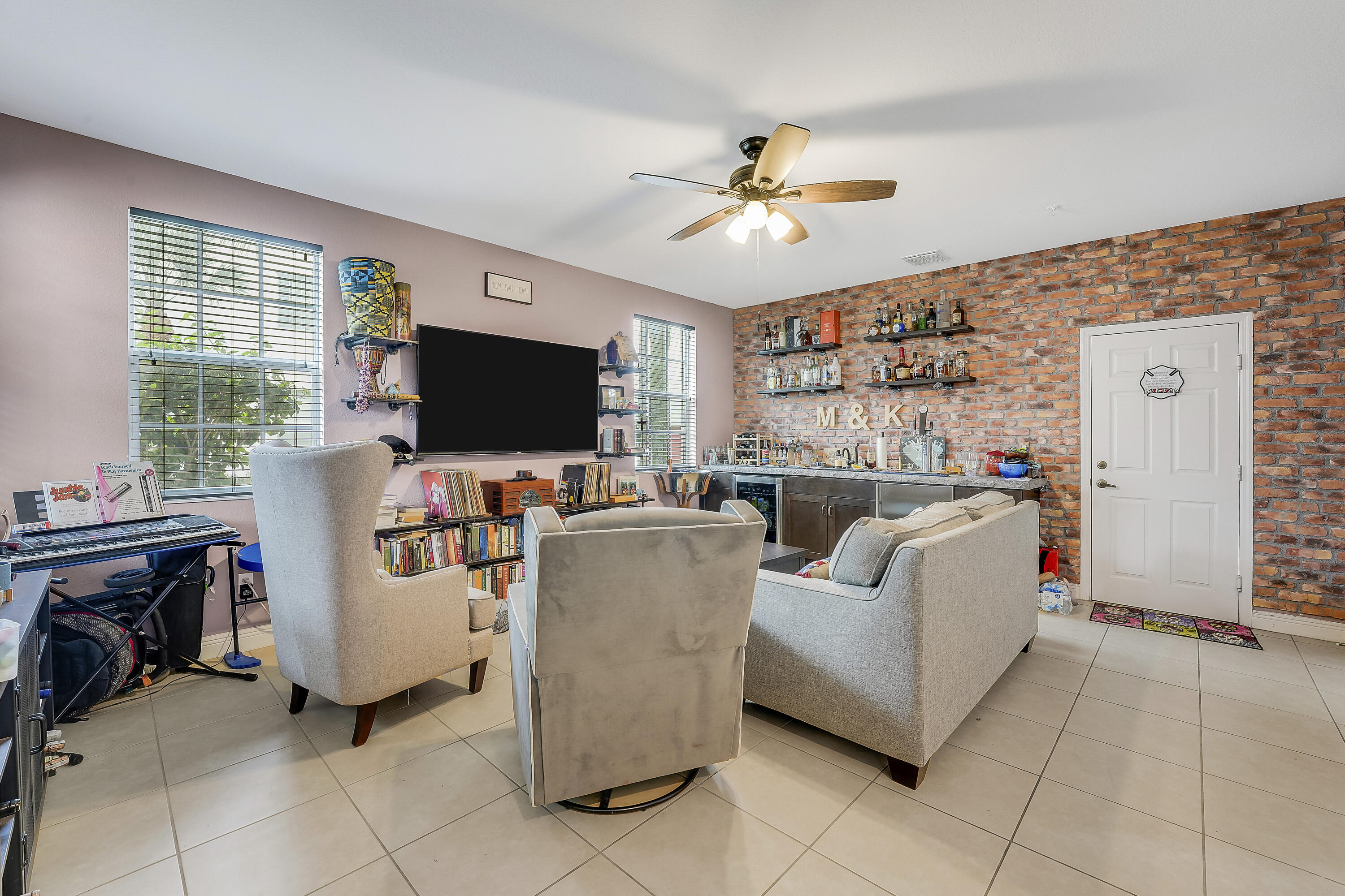 2900 Southwest 119th Way Miramar, FL 33025 - Photo 17 of 37 a living room with furniture and a flat screen tv