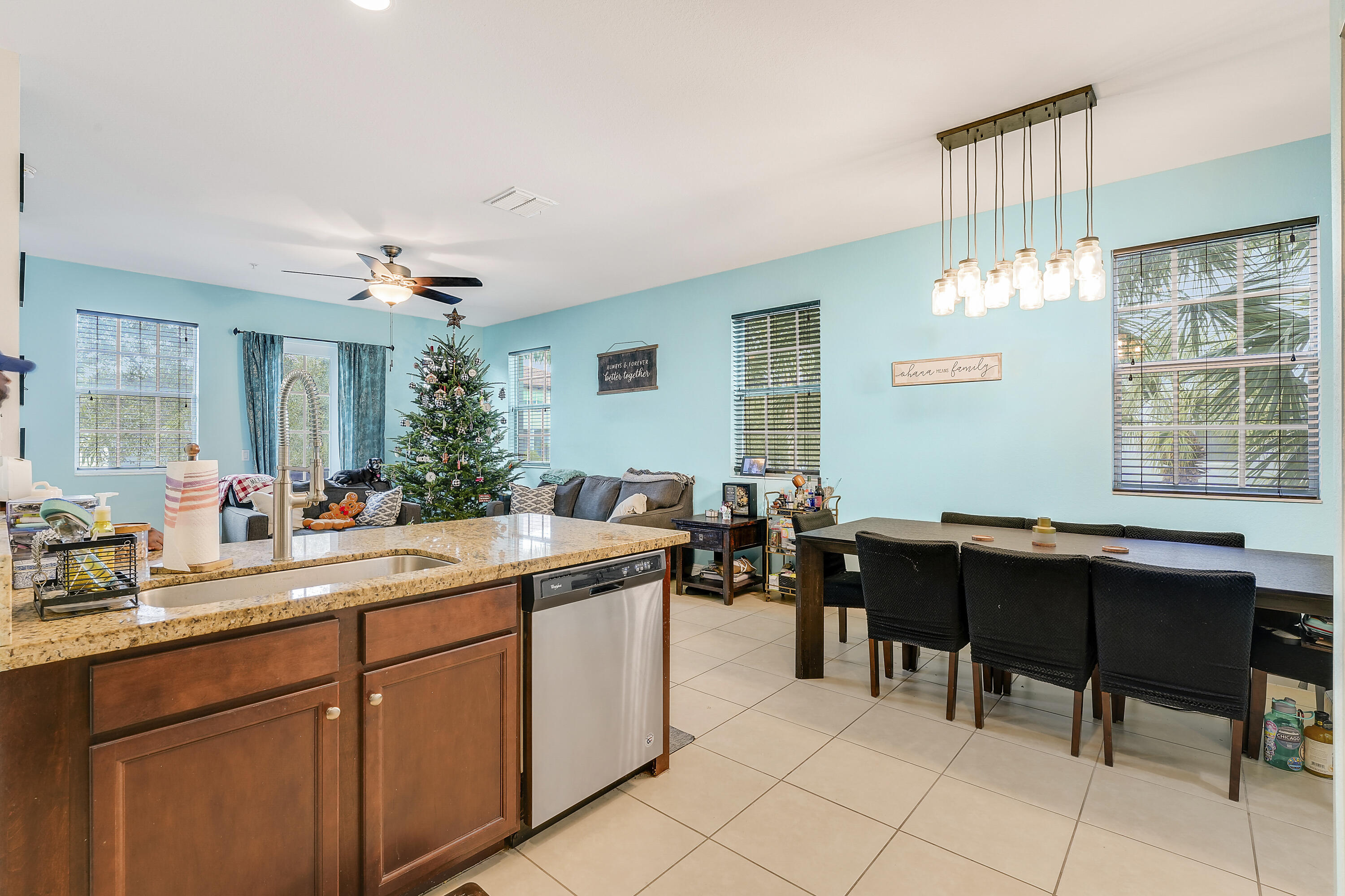 2900 Southwest 119th Way Miramar, FL 33025 - Photo 27 of 37 a room with a wooden cabinets a dining table and a sink
