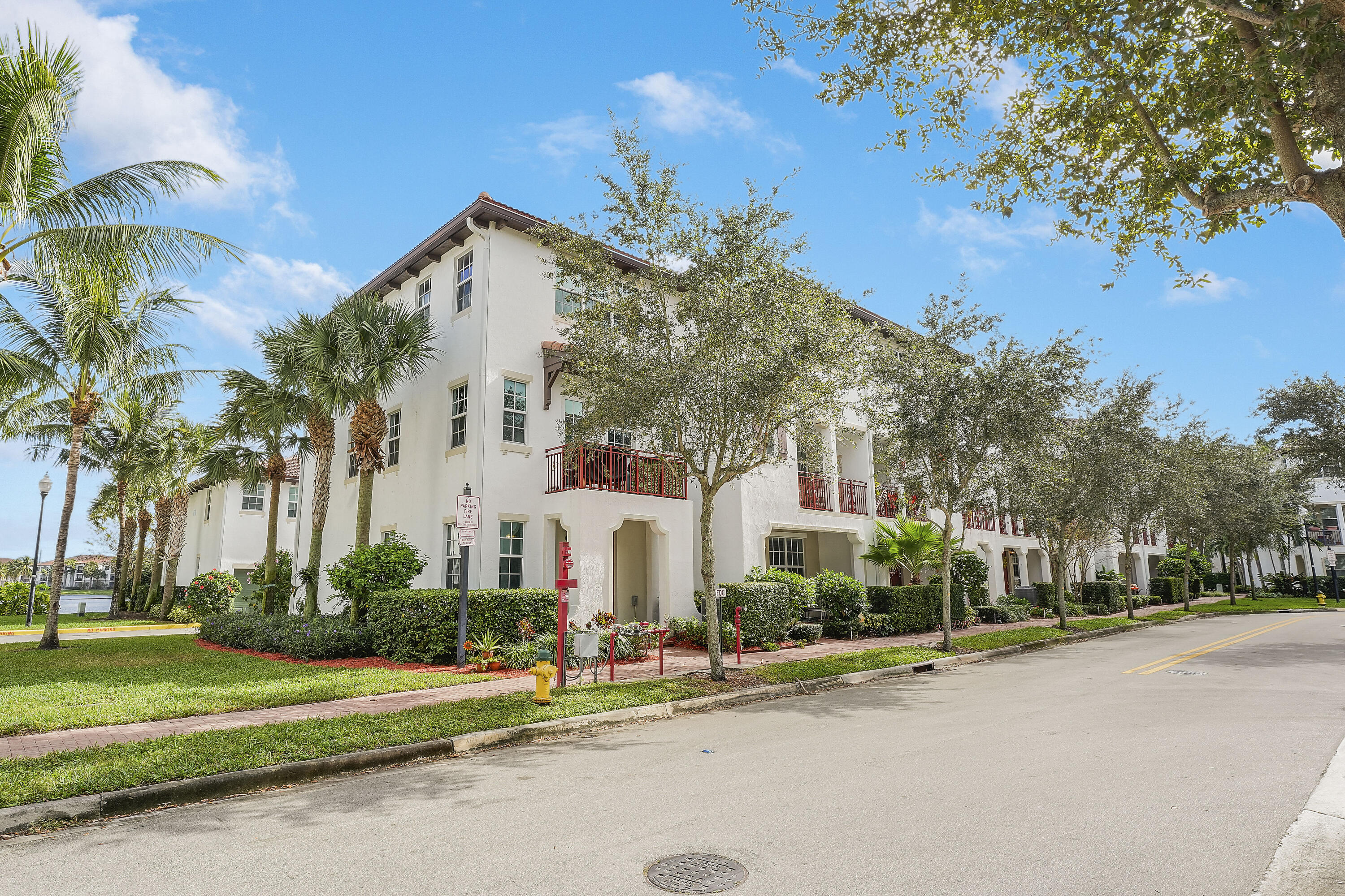 2900 Southwest 119th Way Miramar, FL 33025 - Photo 3 of 37 a view of a white house with a large trees and plants next to a road