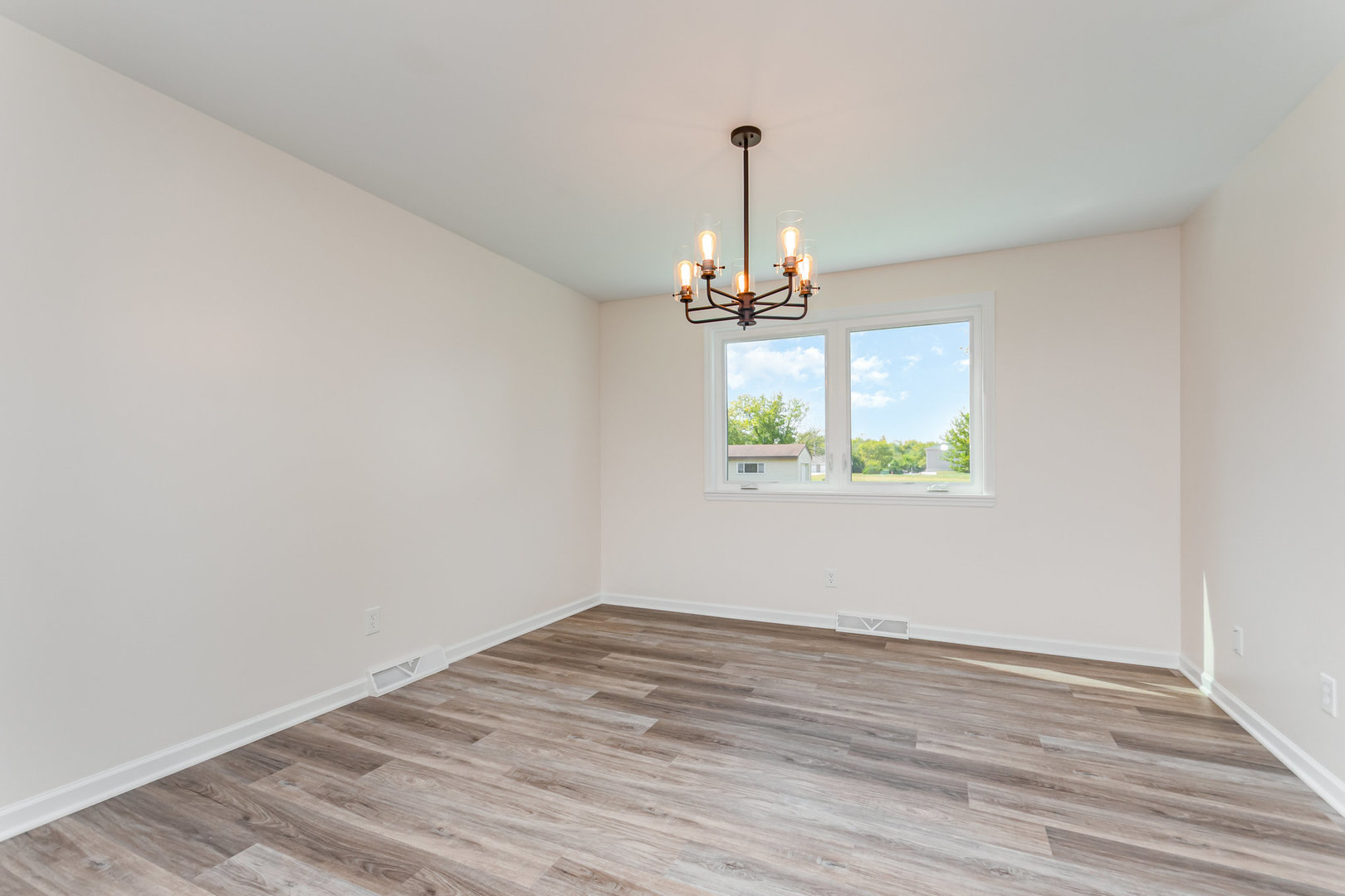 2380 Chestnut Lane Morris, IL 60450 - Photo 8 of 25 a view of empty room with window and wooden floor
