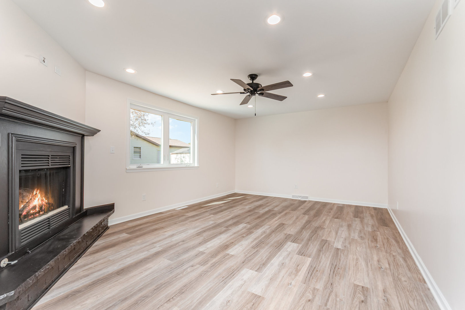 2380 Chestnut Lane Morris, IL 60450 - Photo 9 of 25 a view of an empty room with a fireplace and a window