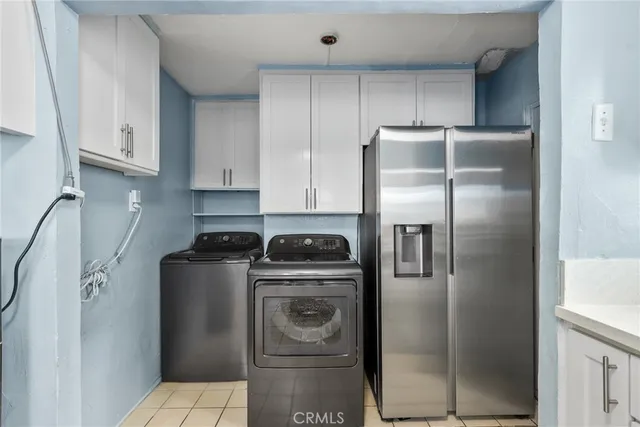a kitchen with a refrigerator sink and cabinets