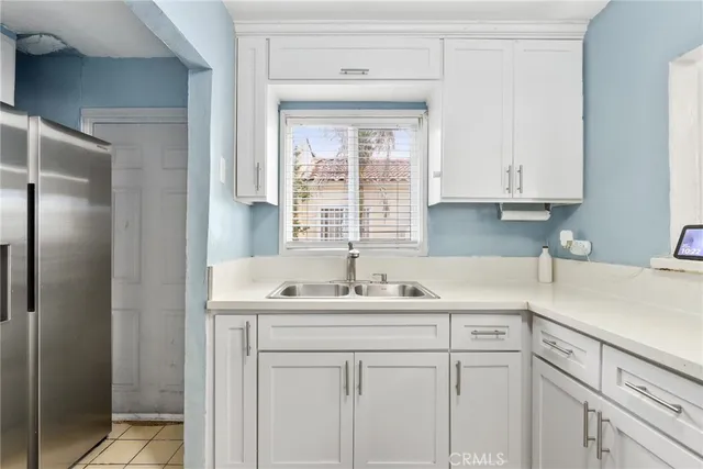 a kitchen with a sink cabinets and window
