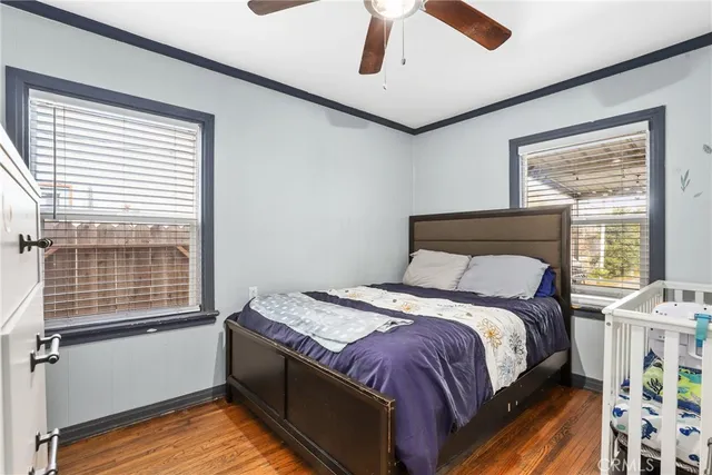 a bed sitting in a bedroom next to a window