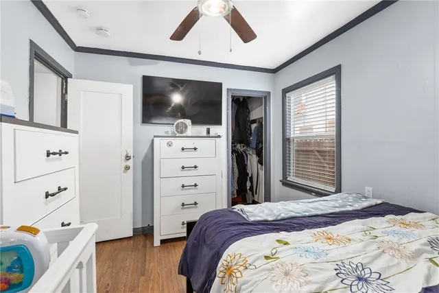 a bedroom with a bed and a flat screen tv