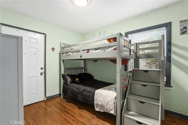 a bedroom with a bed and a mirror