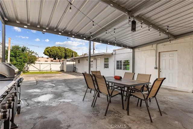 a view of a patio with table and chairs with wooden floor