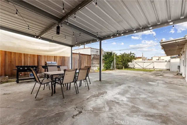 a view of a patio with table and chairs