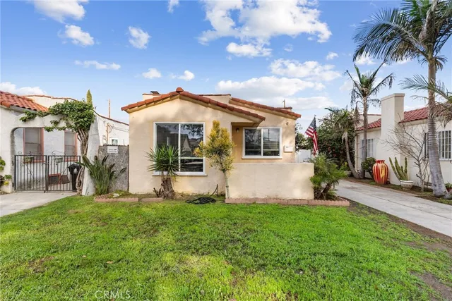 a front view of a house with garden and porch