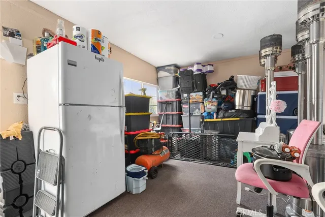 a view of a patio with table and chairs a barbeque with wooden fence