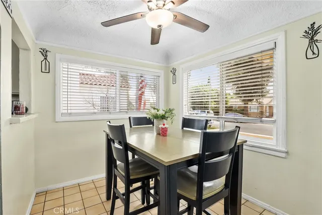 a view of a dining room with a table and chairs