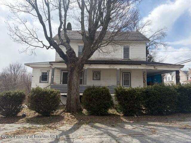 a house that has a tree in front of the house