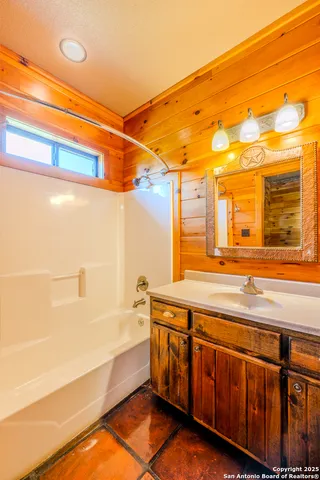 a bathroom with a tub and a sink