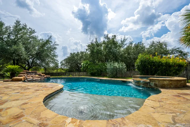 a view of swimming pool with seating space