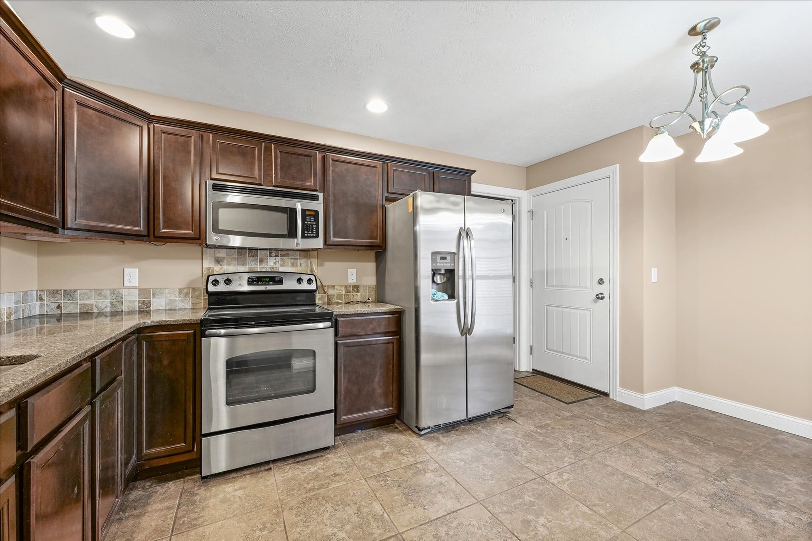 2521 Pembrook Point Champaign, IL 61821 - Photo 12 of 31 a kitchen with stainless steel appliances granite countertop a refrigerator a stove a sink and dishwasher