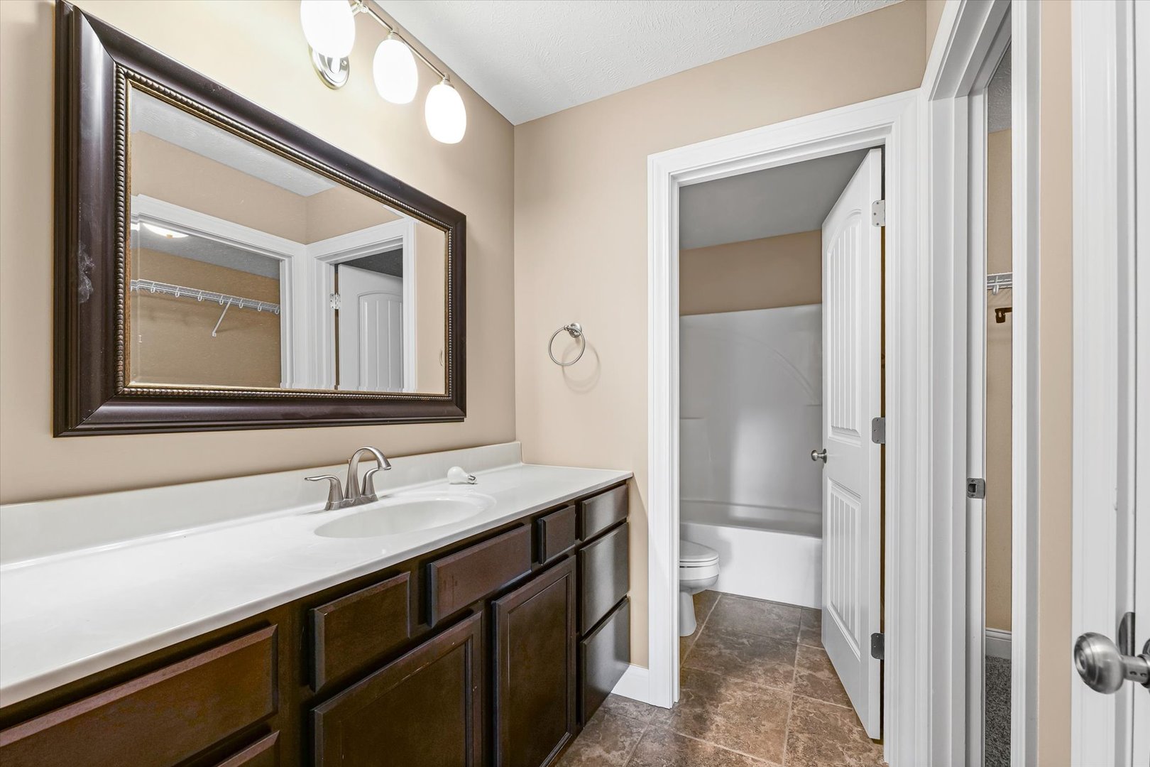 2521 Pembrook Point Champaign, IL 61821 - Photo 19 of 31 a bathroom with a sink a toilet and a mirror