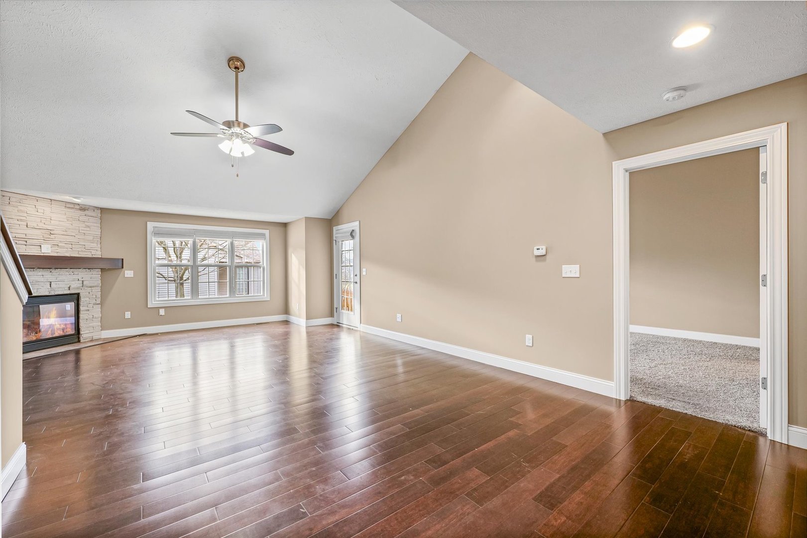 2521 Pembrook Point Champaign, IL 61821 - Photo 7 of 31 a view of an empty room with wooden floor and a window
