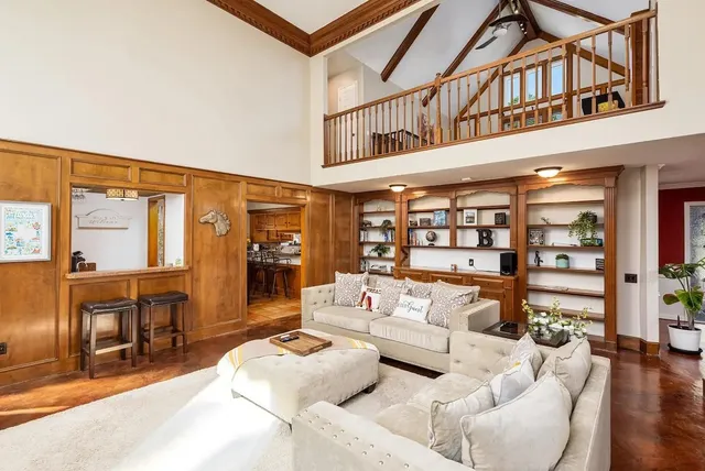 a living room with furniture a rug and a window