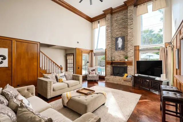 a living room with furniture a flat screen tv and a fireplace