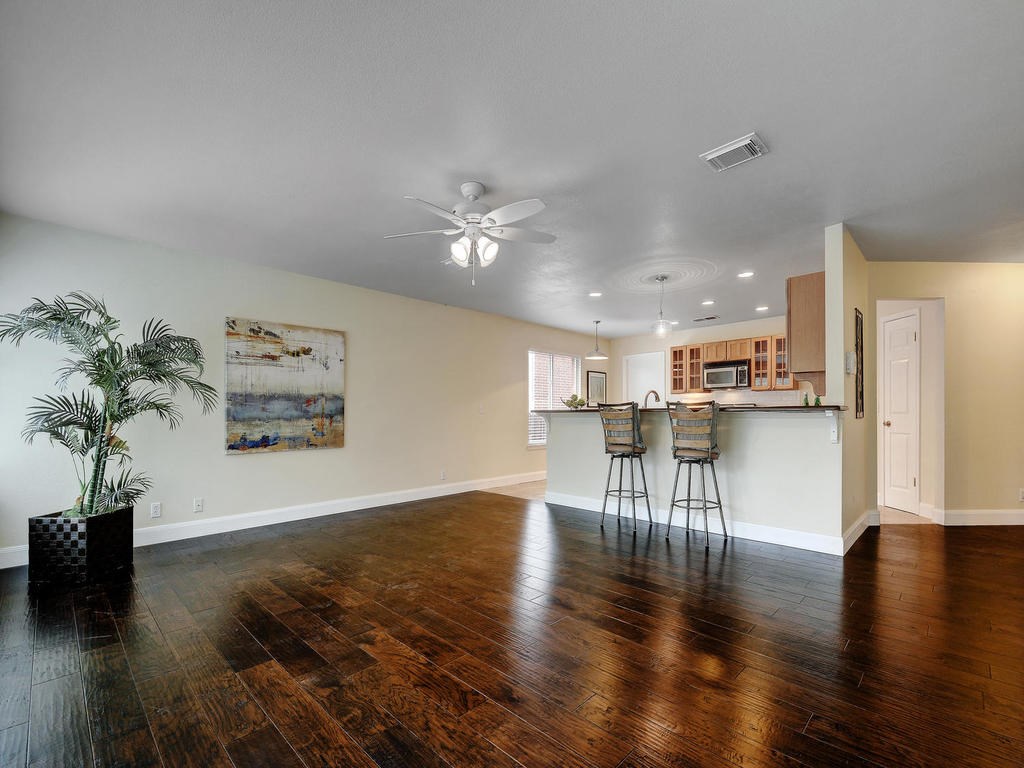 9012 Colberg Drive Austin, TX 78749 - Photo 1 of 1 a view of a kitchen with furniture and a wooden floor