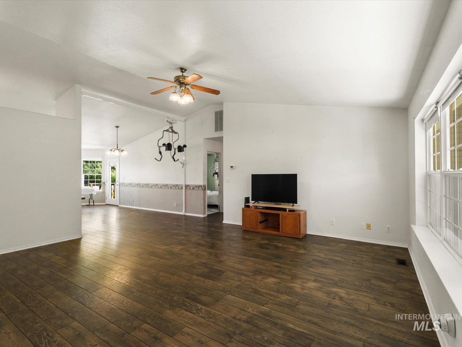 3540 Wills Road Emmett, ID 83617 - Photo 8 of 36 Spacious living area featuring wood-finish flooring, vaulted ceilings, and a ceiling fan with integrated lighting