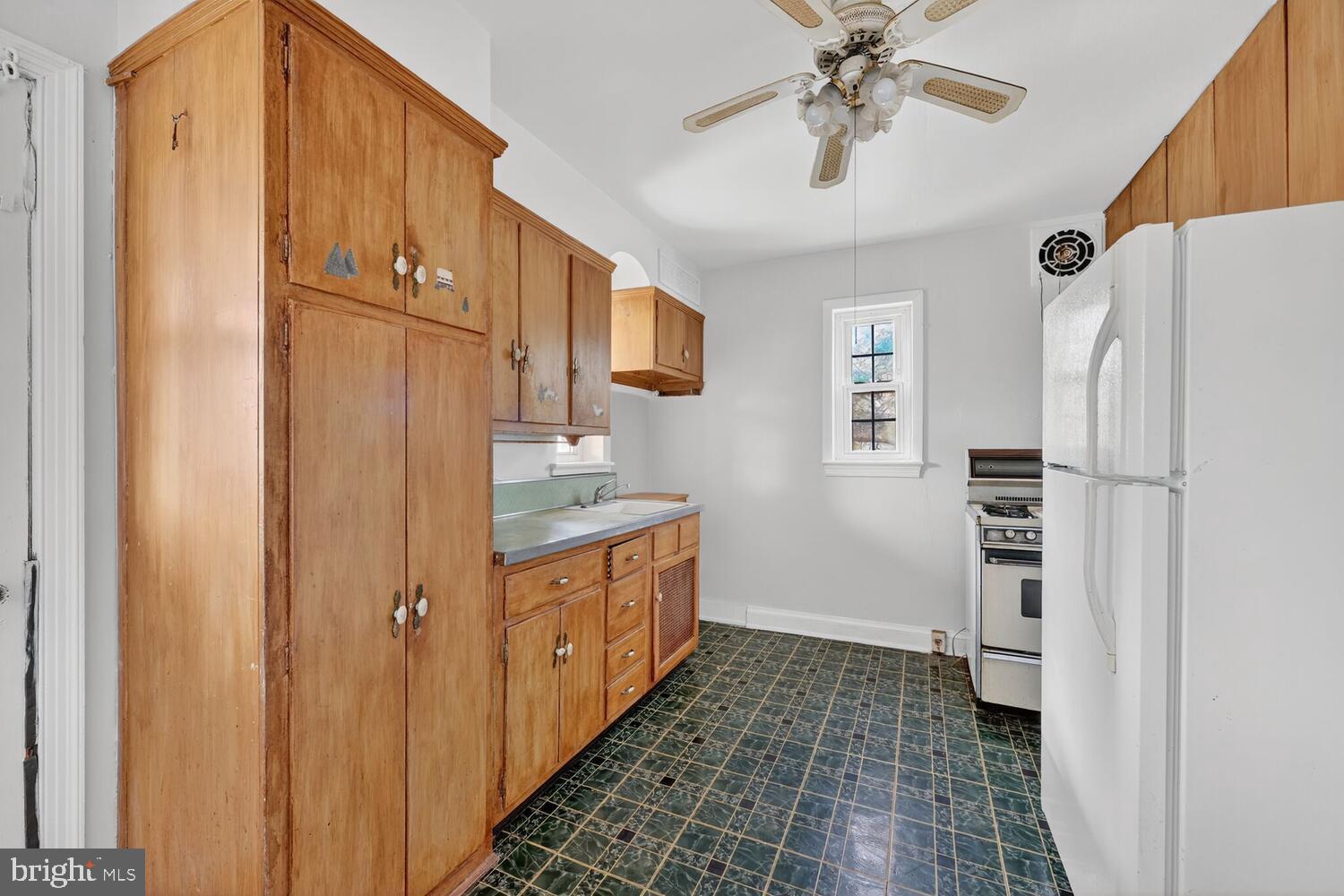 3701 Camden Street Southeast Washington, DC 20020 - Photo 12 of 33 a kitchen with stainless steel appliances a refrigerator and a chandelier