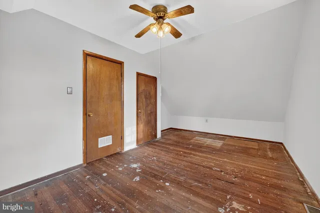 a view of a room with a sink and a chandelier fan