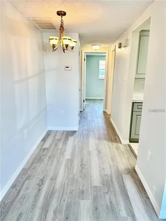 a view of a room with wooden floor and staircase