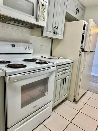 a stove top oven sitting inside of a kitchen
