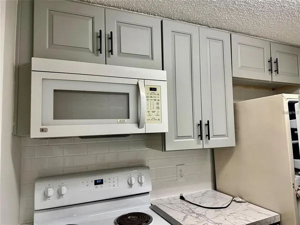 a stove top oven sitting inside of a kitchen