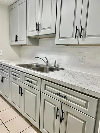 a kitchen with white cabinets and white appliances