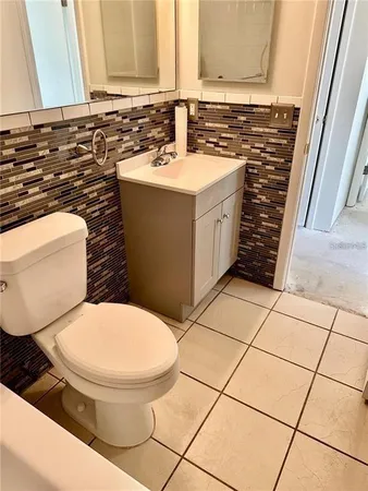 a bathroom with a sink toilet and mirror