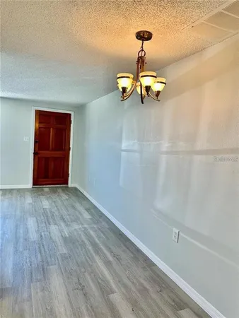 a view of a room with wooden floor and window