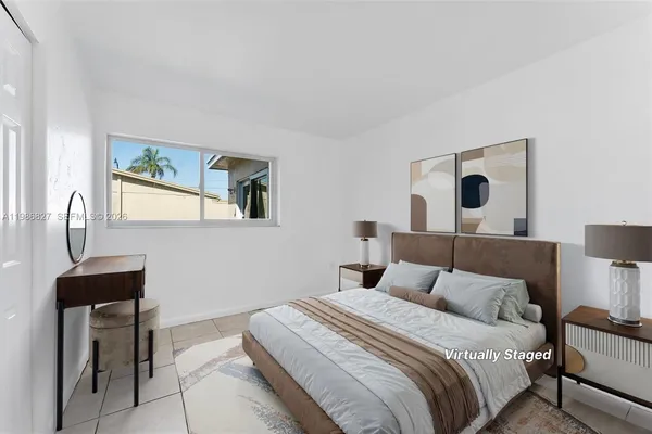 a bedroom with a bed and a lamp on table