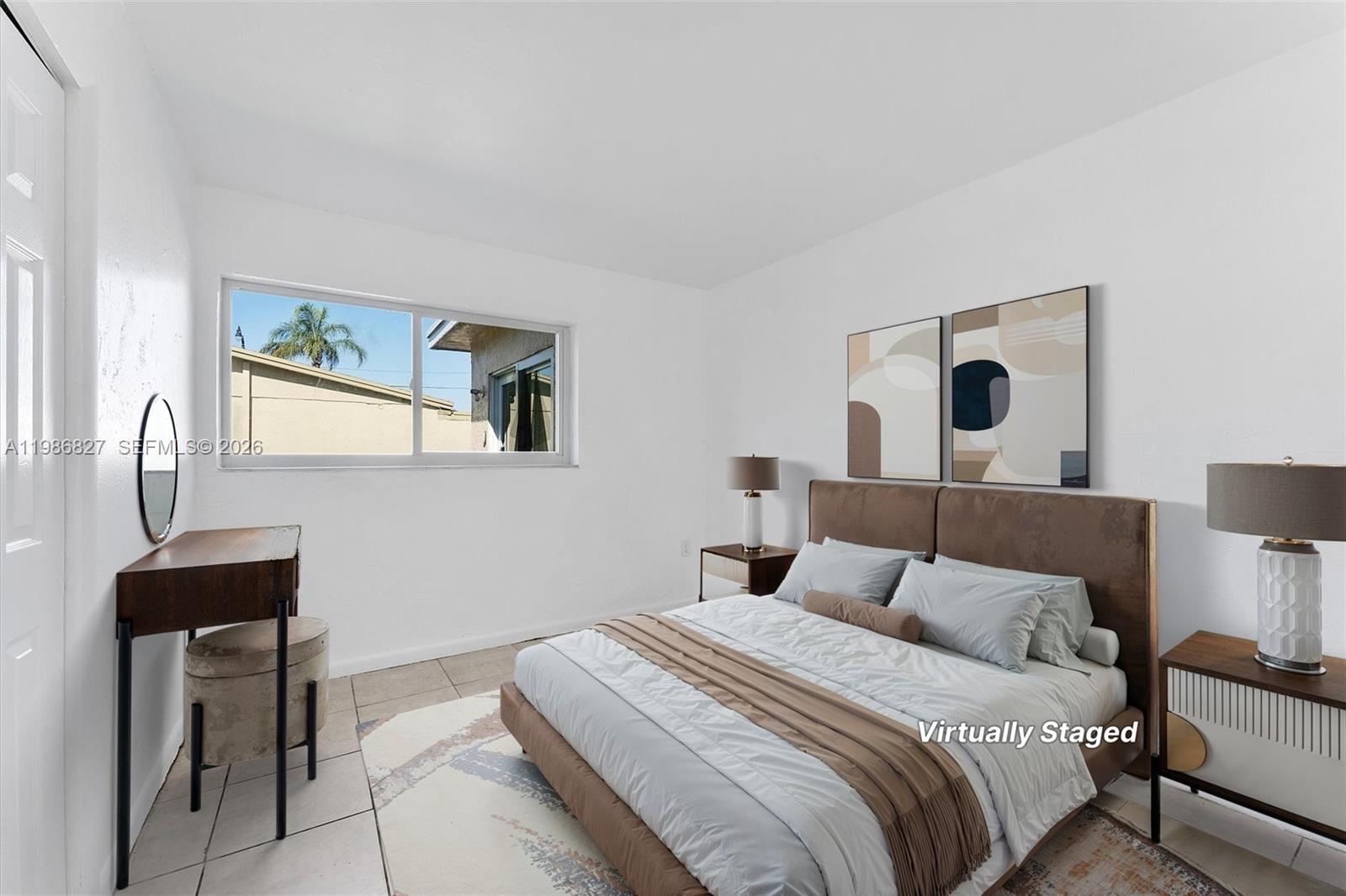 550 Northwest 17th Street Pompano Beach, FL 33060 - Photo 14 of 31 a bedroom with a bed and a lamp on table