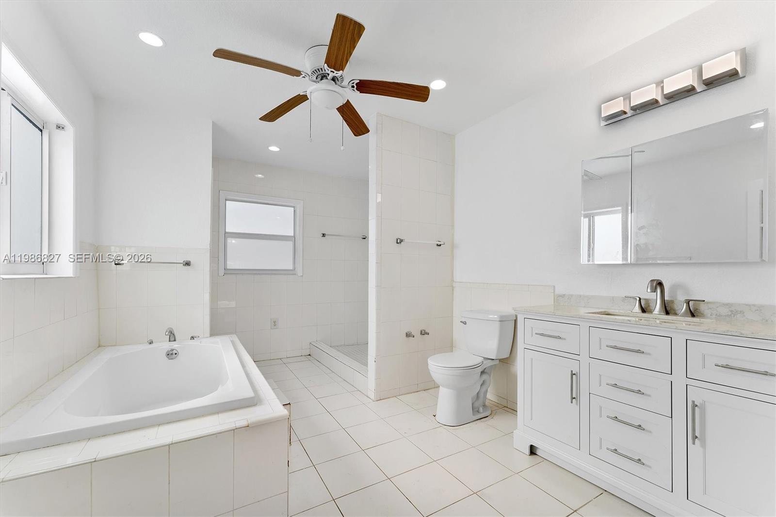 550 Northwest 17th Street Pompano Beach, FL 33060 - Photo 20 of 31 a bathroom with a toilet sink and mirror